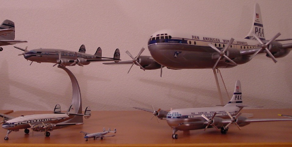 On the left are three examples of the Lockheed Constellation.  On the right two examples of the Boeing Stratocruiser.